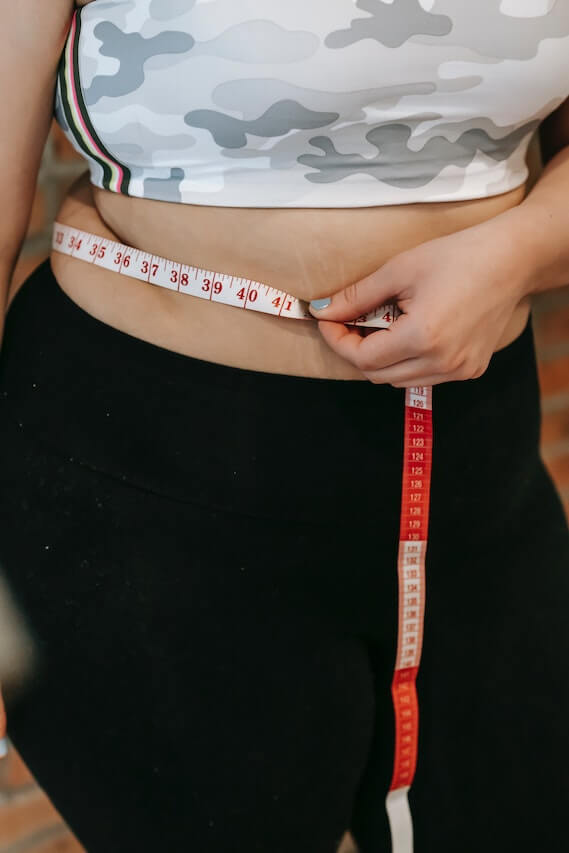 woman-measuring-her-waist