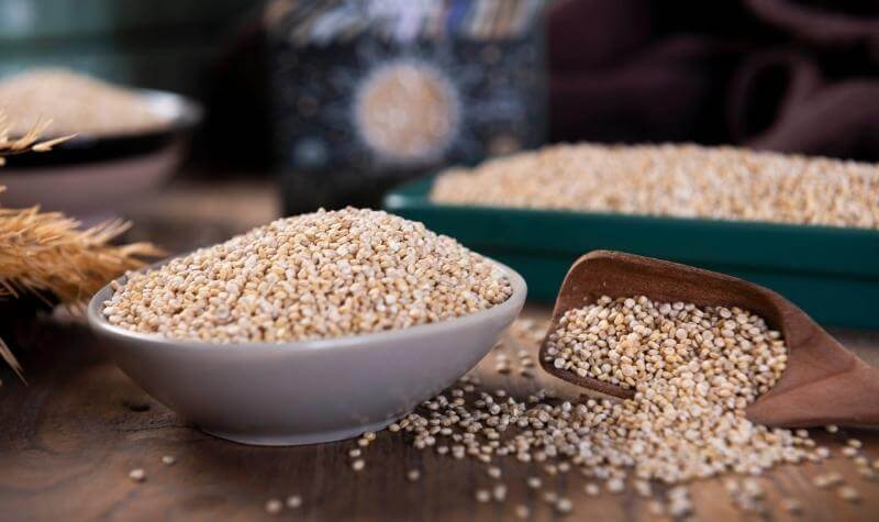 Large bowl of quinoa on a wooden table as part of a mediterranean diet