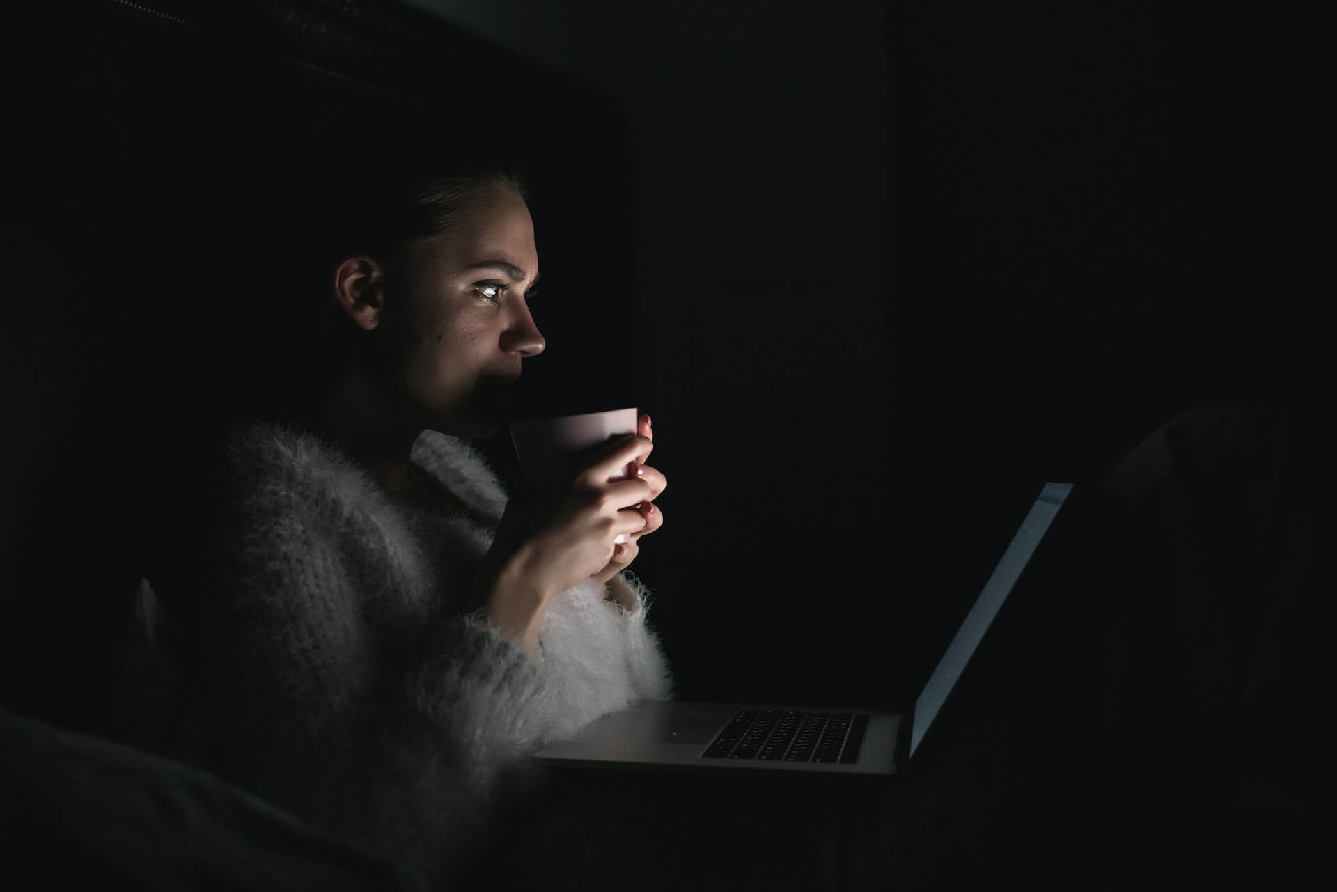 Woman-drinking-coffee-late-at-night-with-a-screen-on-night-eating-syndrome