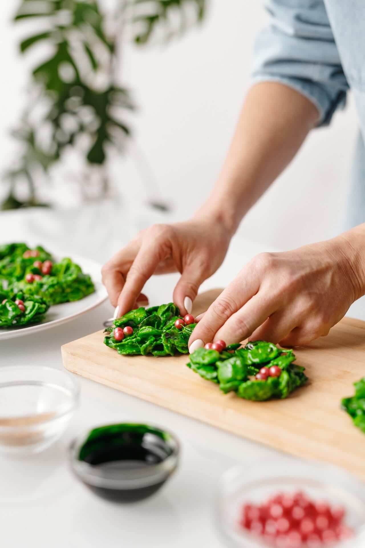 Person-Putting-Vegetable-Salad-on-a-Wooden-Tray