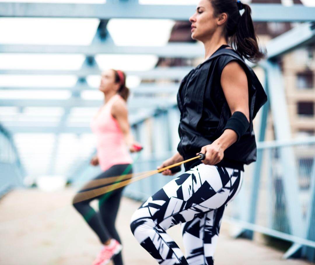 two women jumping rope for fitness