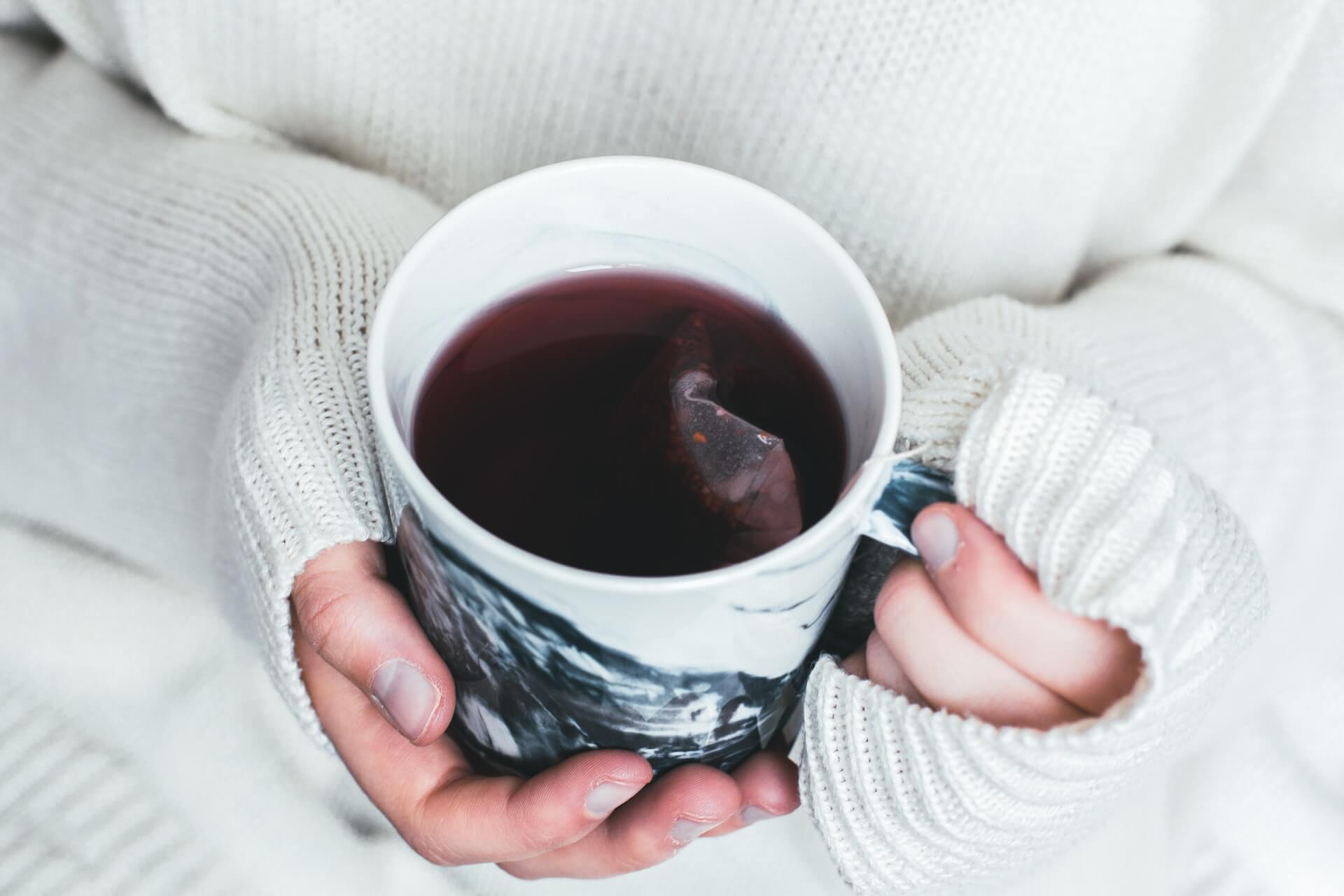 woman holding a cup of tea