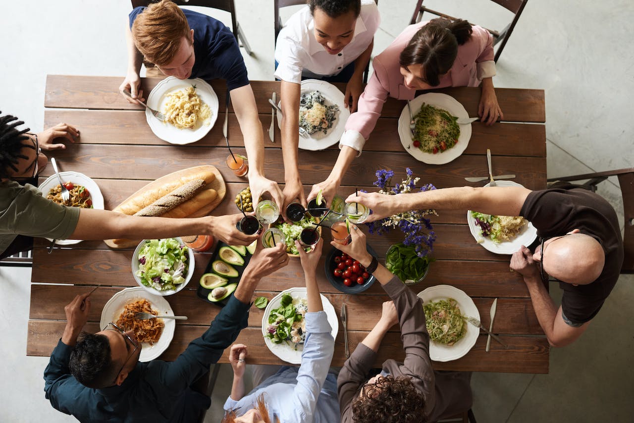 a-group-of-people-toasting-to-thanksgiving-at-dinner