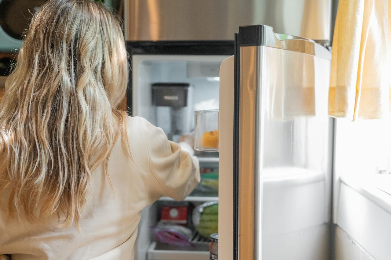 woman-getting-some-foods-in-the-refrigerator