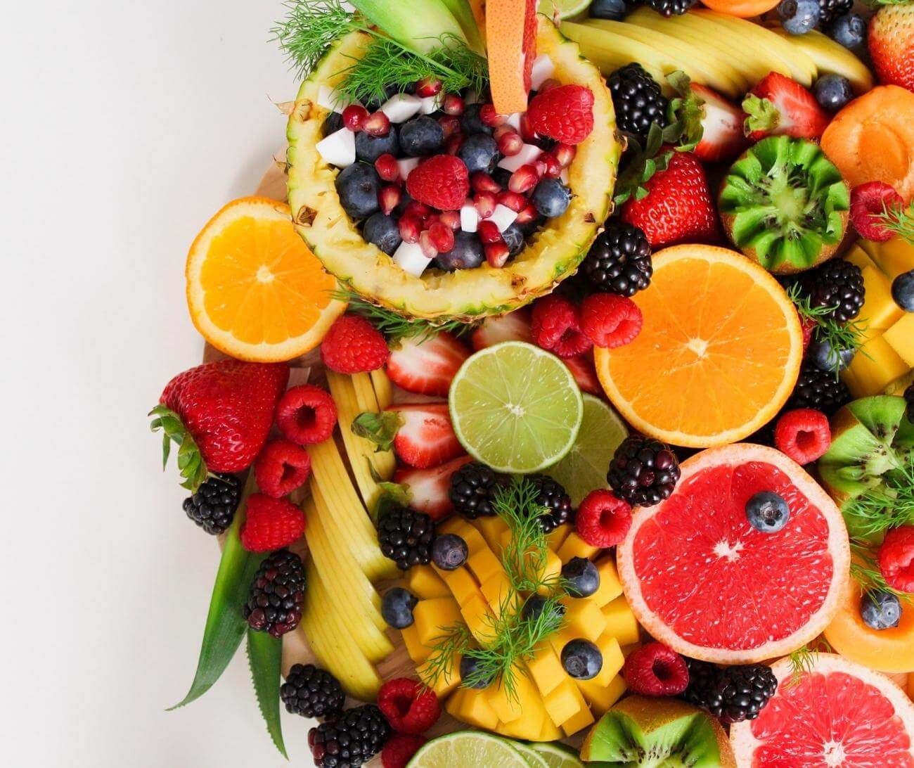 Various low glycemic fruits displayed on a round tabletop