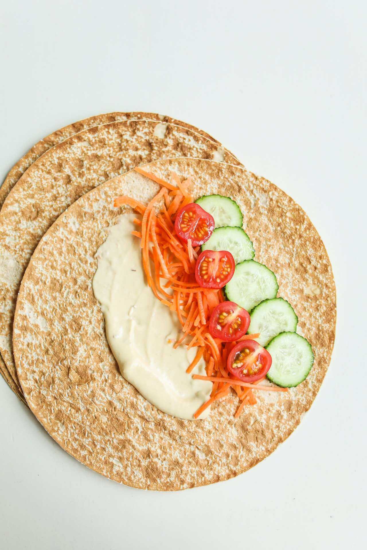 Pita-bread-with-hummus-tomatoes-cucumber-and-carrot-on-top