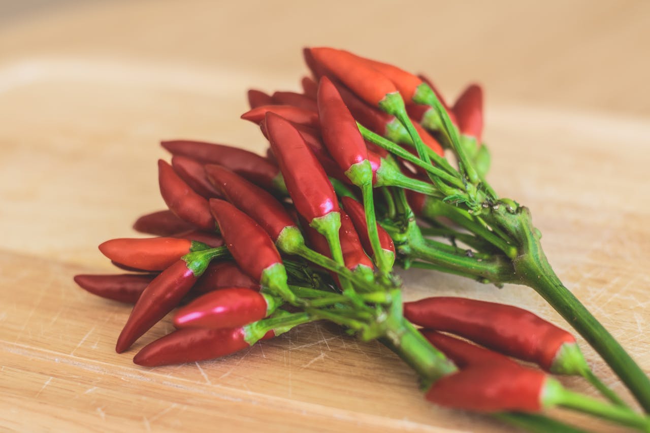 red peppers piled over a wooden counter