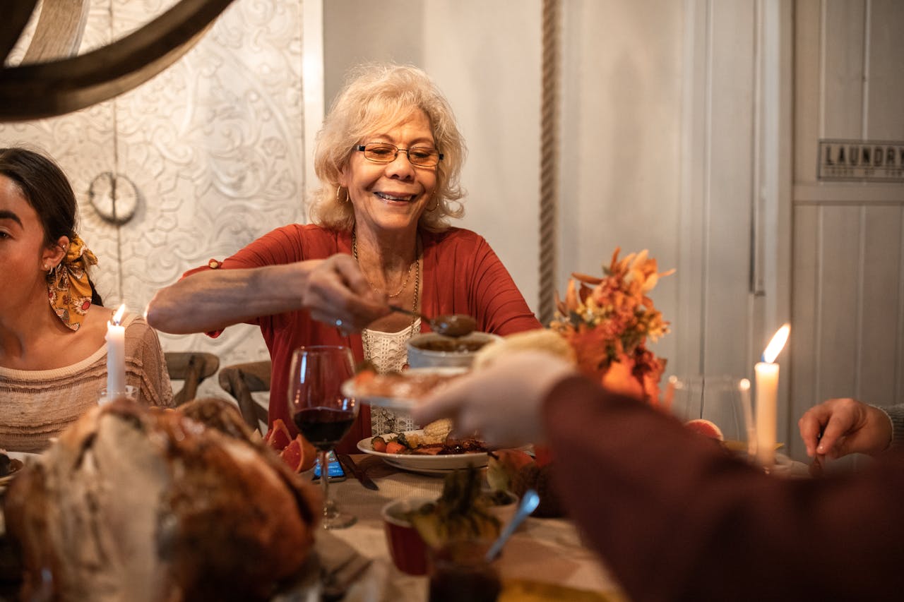 Old woman smiling while serving herself some food