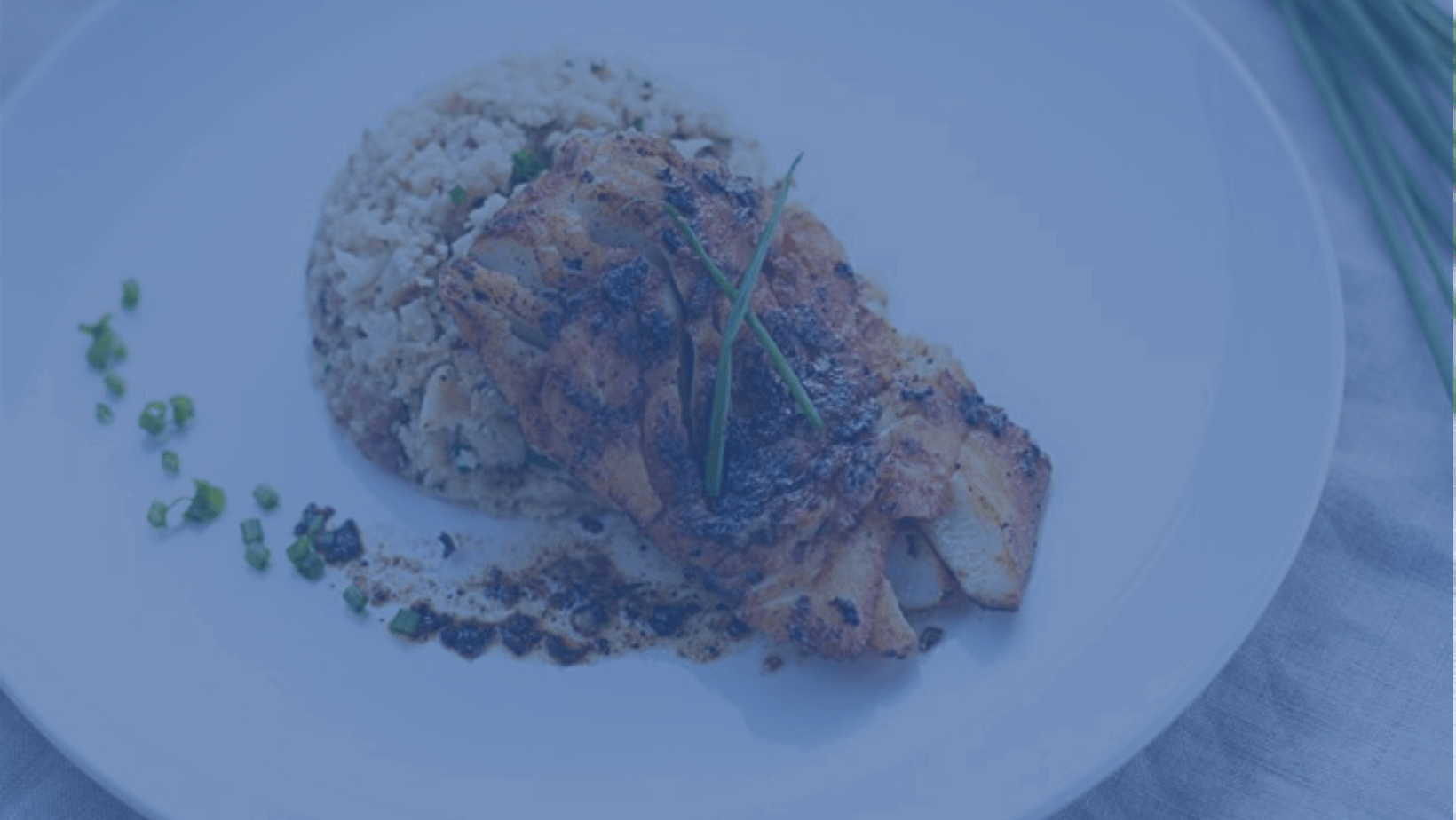 Cashew crusted cod with roasted cauliflower on a white plate